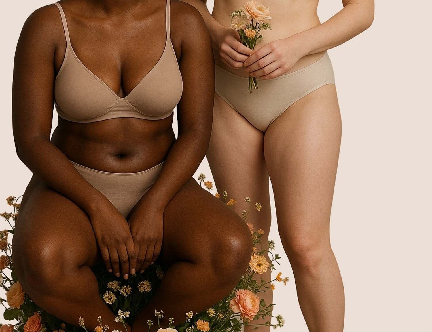 Model seated in beige lingerie, showcasing tattoos.